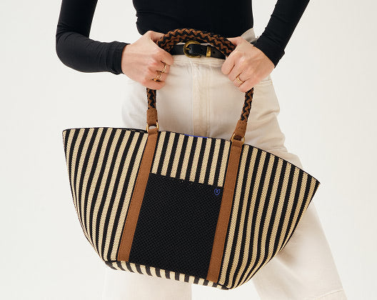 Model holding The Summer tote with both hands
