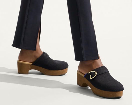 Close-up of a woman's feet wearing the classic clog, highlighting a relaxed and casual footwear choice.  