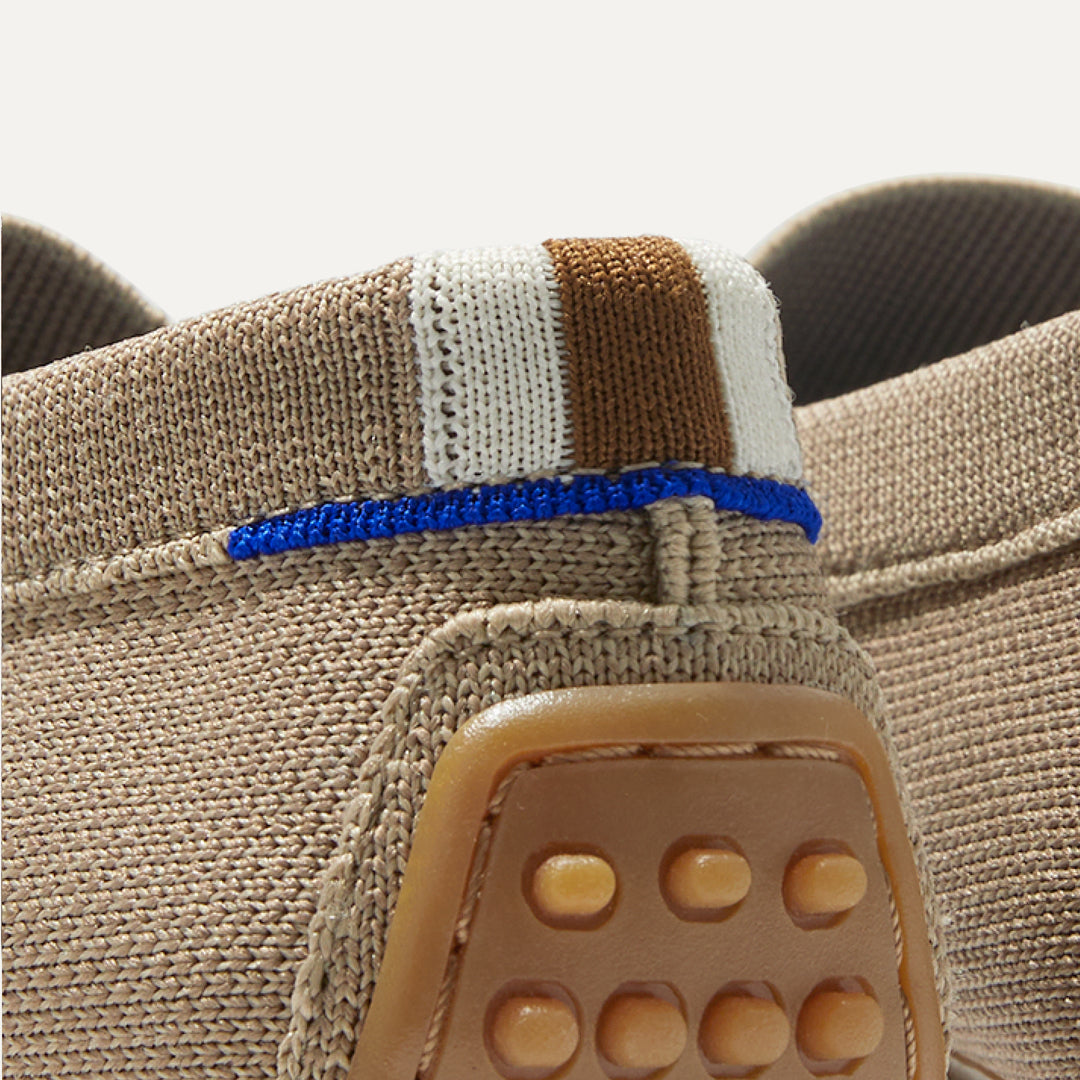 A close up view of the heel of The Driver, showing the heel stripe and Rothy's blue halo.